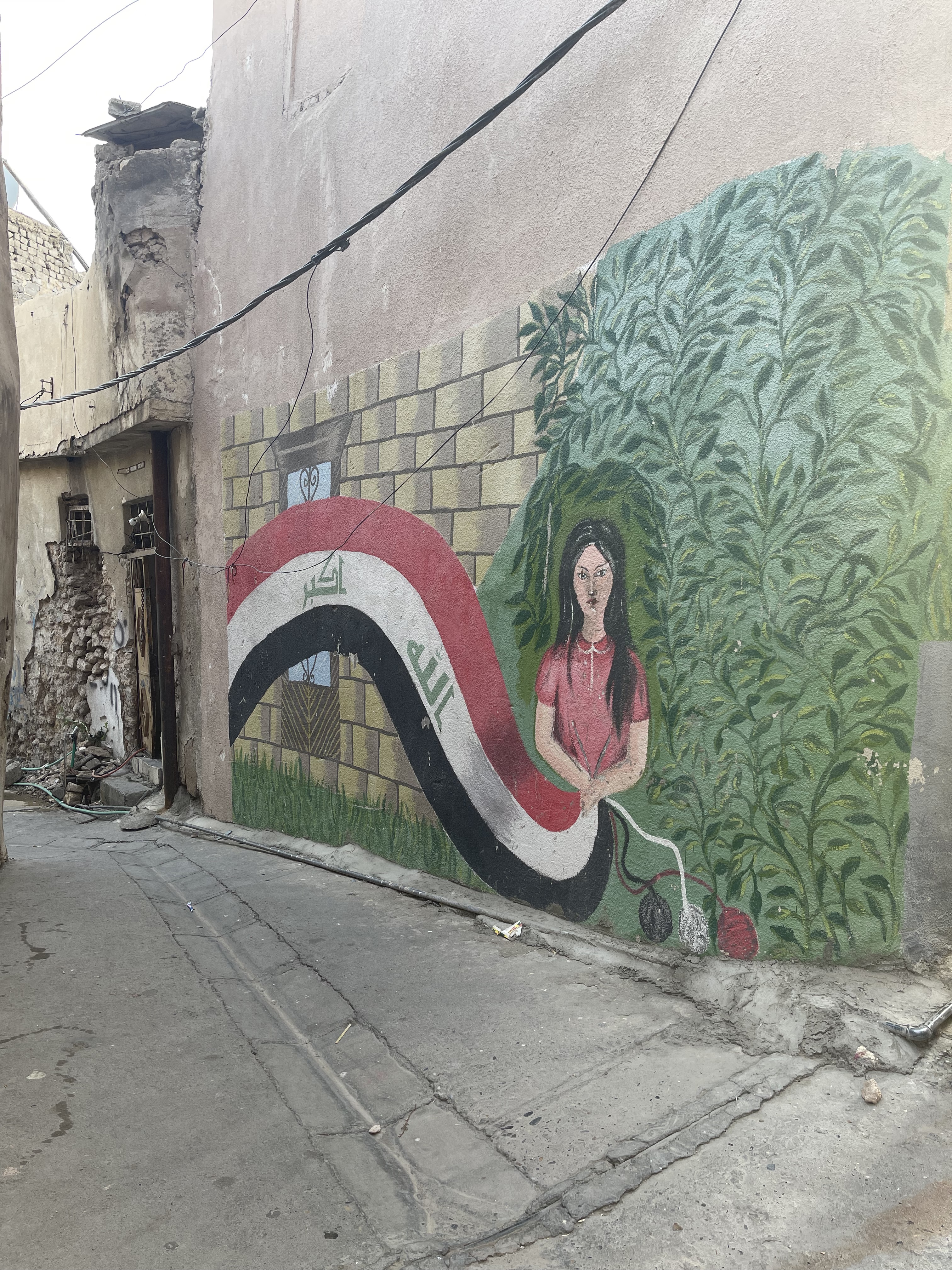 A mural on the side of a city building.